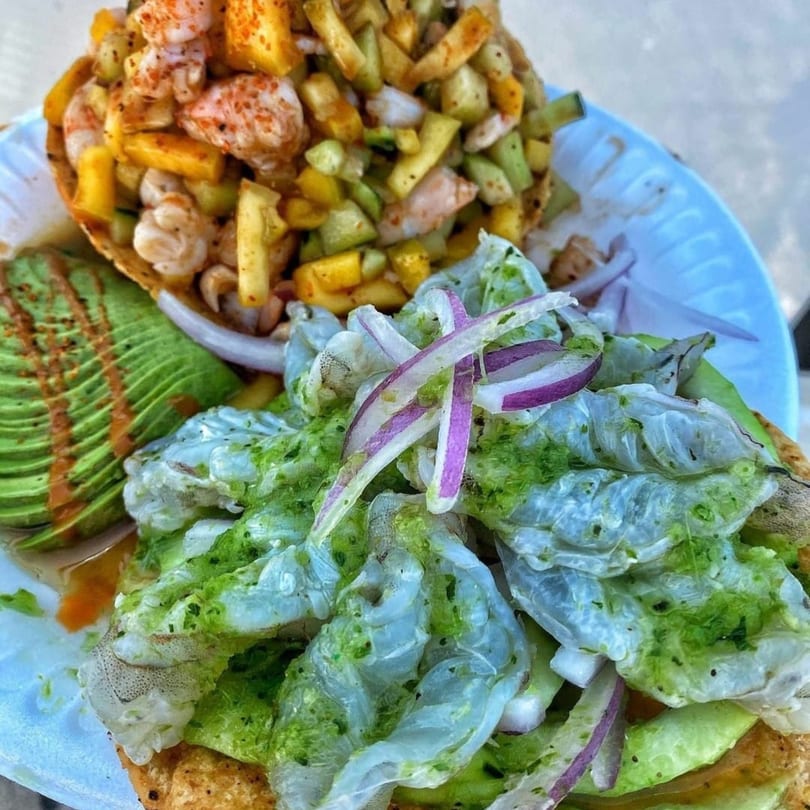 Close-up of La Baja's Mexican shrimp ceviche with avocado, red onion, and green sauce.